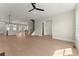Open-concept living area showcasing light wood floors, a kitchen, and a staircase at 1929 Quarry Park Nw Pl, Atlanta, GA 30318
