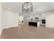 Spacious living room with modern lighting, marble island, hardwood floors, and an open floor plan at 1929 Quarry Park Nw Pl, Atlanta, GA 30318