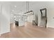 Spacious living room with an island, hardwood floors, staircase and modern lighting fixtures at 1929 Quarry Park Nw Pl, Atlanta, GA 30318