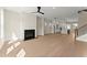 Bright, open-concept living space with fireplace, light wood floors, and kitchen view at 1929 Quarry Park Nw Pl, Atlanta, GA 30318