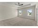Large bedroom featuring plush carpeting, a tray ceiling, and abundant natural light at 1929 Quarry Park Nw Pl, Atlanta, GA 30318