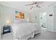 Bright bedroom featuring a large bed, beach-themed art, and an ensuite bathroom at 330 Cottonwood Creek Cir, Canton, GA 30114
