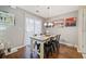 Inviting dining area featuring a modern chandelier, stylish table setting, and ample natural light at 330 Cottonwood Creek Cir, Canton, GA 30114