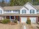 Exterior view of a townhome with a one car garage, and a charming front porch at 330 Cottonwood Creek Cir, Canton, GA 30114