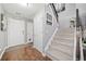 Welcoming foyer with wood floors, staircase, and ample natural light. Freshly painted in gray tones at 330 Cottonwood Creek Cir, Canton, GA 30114