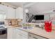Well-lit kitchen with stainless steel sink, stainless steel dishwasher, and view of living room at 330 Cottonwood Creek Cir, Canton, GA 30114