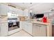 Bright kitchen features white cabinets, stainless steel dishwasher, and a view to the living room at 330 Cottonwood Creek Cir, Canton, GA 30114