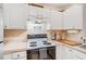 Kitchen showcasing white cabinets, countertop appliances, and black stove-top oven at 330 Cottonwood Creek Cir, Canton, GA 30114