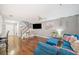 Bright living room with hardwood floors, comfortable seating, and easy access to the staircase at 330 Cottonwood Creek Cir, Canton, GA 30114