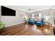 Spacious living room with hardwood floors, comfortable seating, and a large TV at 330 Cottonwood Creek Cir, Canton, GA 30114