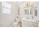 Elegant powder room featuring a decorative mirror, stylish vanity, and modern fixtures at 330 Cottonwood Creek Cir, Canton, GA 30114