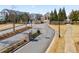 Grand entrance to a gated community, featuring manicured landscaping and brick accents at 10162 Windalier Way, Roswell, GA 30076