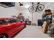 Spacious garage featuring epoxy floors, ample storage, and a red car parked inside, showing practicality at 10162 Windalier Way, Roswell, GA 30076