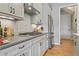 A cooktop, stainless steel appliances and gray cabinets are shown at 10162 Windalier Way, Roswell, GA 30076