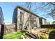 Exterior view of a home's fenced backyard with a patio and mature trees at 103 Magnaview Dr, Mcdonough, GA 30253