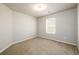 This bedroom features carpet flooring and a window with blinds at 103 Magnaview Dr, Mcdonough, GA 30253