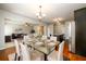 Formal dining room with a glass-top table, seating for six, and a stylish chandelier at 103 Magnaview Dr, Mcdonough, GA 30253