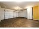 Garage space featuring wood look floors and a white garage door at 103 Magnaview Dr, Mcdonough, GA 30253