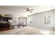 Open living room with a view into the kitchen, neutral carpeting, and abundant natural light at 103 Magnaview Dr, Mcdonough, GA 30253