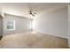 This living room features carpet flooring and two windows with blinds at 103 Magnaview Dr, Mcdonough, GA 30253