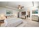 This main bedroom features a tray ceiling, ceiling fan, and ensuite bathroom at 103 Magnaview Dr, Mcdonough, GA 30253
