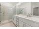 Bathroom features a double vanity, quartz countertop, gold hardware, and glass enclosed shower at 1937 Quarry Park Nw Pl, Atlanta, GA 30318