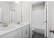 Modern bathroom featuring double sinks with brass fixtures, a toilet, and a tiled bathtub at 1937 Quarry Park Nw Pl, Atlanta, GA 30318