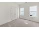 Bright, carpeted bedroom with large windows and a double door closet at 1937 Quarry Park Nw Pl, Atlanta, GA 30318