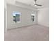 Bright, carpeted bedroom with a tray ceiling and natural light from two windows at 1937 Quarry Park Nw Pl, Atlanta, GA 30318