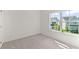Bright, carpeted bedroom with a large window overlooking the neighborhood at 1937 Quarry Park Nw Pl, Atlanta, GA 30318