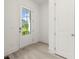 Inviting entryway with a glass door, light flooring, and a convenient closet for storage at 1937 Quarry Park Nw Pl, Atlanta, GA 30318