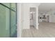 Bright entryway featuring light wood flooring, open access to the kitchen, and a convenient half bath at 1937 Quarry Park Nw Pl, Atlanta, GA 30318