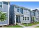Modern new construction home featuring blue exterior, well-kept lawn, and inviting front entrance at 1937 Quarry Park Nw Pl, Atlanta, GA 30318
