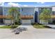 Exterior view of blue townhomes with garages, driveways, upper level decks and landscaped yards create curb appeal at 1937 Quarry Park Nw Pl, Atlanta, GA 30318