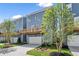 Exterior of townhomes showcases attached garages, upper decks, driveways, and beautifully landscaped yards and gardens at 1937 Quarry Park Nw Pl, Atlanta, GA 30318