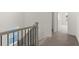 Carpeted hallway with wooden railing at 1937 Quarry Park Nw Pl, Atlanta, GA 30318