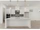 Bright kitchen featuring stainless appliances, an island, and gray backsplash at 1937 Quarry Park Nw Pl, Atlanta, GA 30318