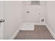 The laundry room has tile floors, utility connections, and a small shelf above the washer at 1937 Quarry Park Nw Pl, Atlanta, GA 30318