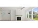 Bright living room with a modern fireplace, large windows, and a stylish ceiling fan at 1937 Quarry Park Nw Pl, Atlanta, GA 30318