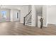 Open-concept living area with hardwood floors and staircase with wood railing and iron balusters at 1937 Quarry Park Nw Pl, Atlanta, GA 30318