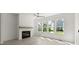 Spacious living room featuring a fireplace, large windows, and light wood flooring at 1937 Quarry Park Nw Pl, Atlanta, GA 30318