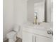 Elegant powder room with white vanity, gold fixtures, and a modern toilet at 1937 Quarry Park Nw Pl, Atlanta, GA 30318
