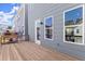 View of the spacious back deck with wooden floors, metal grill, and space for outdoor enjoyment at 1941 Quarry Park Nw Pl, Atlanta, GA 30318