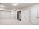 Finished basement area with neutral carpet, recessed lighting, and access to stairs and storage closets at 1941 Quarry Park Nw Pl, Atlanta, GA 30318