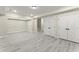 A finished basement with ample lighting and modern flooring leads to a staircase at 1941 Quarry Park Nw Pl, Atlanta, GA 30318