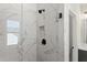 Luxurious shower with marble-look tiling, black fixtures, and a built-in niche at 1941 Quarry Park Nw Pl, Atlanta, GA 30318