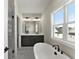 Bright bathroom with marble floors, double vanities, a soaking tub, and a separate shower at 1941 Quarry Park Nw Pl, Atlanta, GA 30318