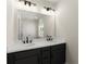 Bathroom featuring black hardware, double vanities, and plenty of storage space at 1941 Quarry Park Nw Pl, Atlanta, GA 30318