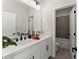 Double vanity bathroom with black hardware, a large mirror, and neutral accents at 1941 Quarry Park Nw Pl, Atlanta, GA 30318