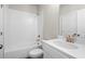 Clean white bathroom with tiled shower/tub combo and vanity with bronze fixtures at 1941 Quarry Park Nw Pl, Atlanta, GA 30318